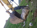 Hydraulic Excavator Thumb HT1850 grasping a large stone