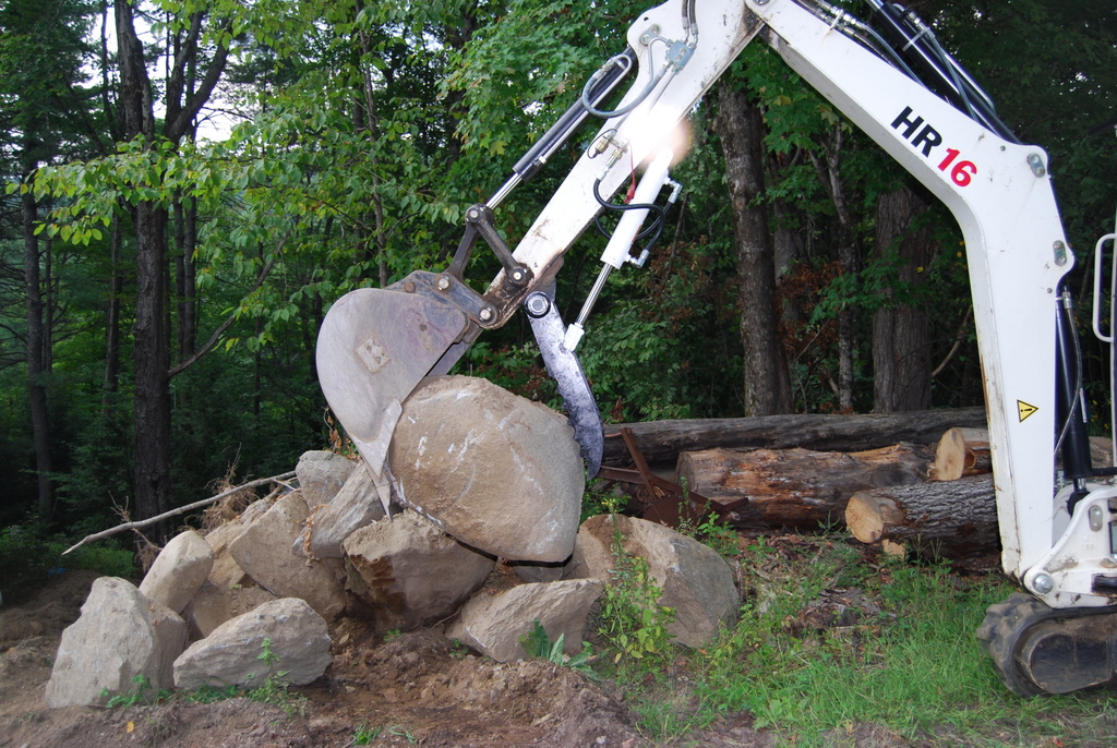 HR16 with mini hydraulic thumb ht830 picking up a stone