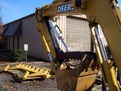 Black HT830 hydraulic thumb installed on a Deere excavator