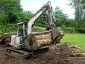 ht830 hydraulic mini excavator thumb shown lifting a tree log