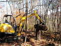 another action shot of the mustang me3003 picking up a log with the HT830 hydraulic mini excavator thumb by USA Attachments