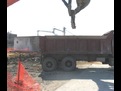 mt3070 excavator thumb loading material into a dump truck