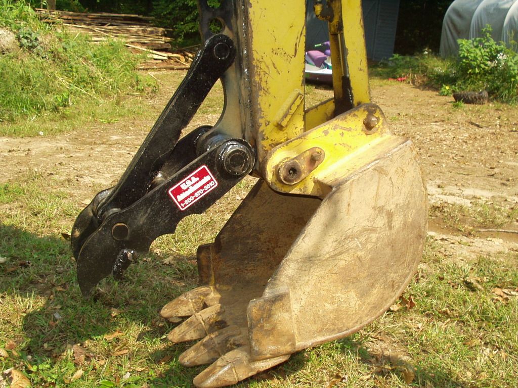An 6" x 18" mini thumb installed on a Terramite T5C compact loader backhoe.