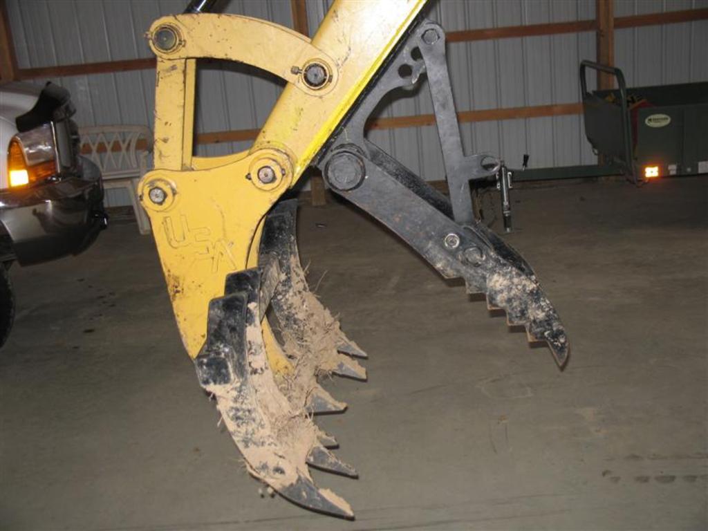 mt830 mini excavator thumb installed with tree stumper and rake