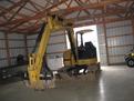 mt830 mini excavator thumb installed along with a tree stumper and rake from USA Attachments