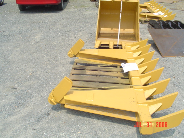 DR-116-10-5x5 Dozer Root Rake in front of an excavator bucket