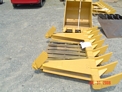 DR-116-10-5x5 Dozer Root Rake in front of an excavator bucket