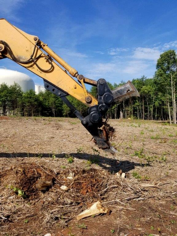 excavator stump splitter splitting a stump