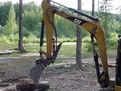 HT830 mini excavator thumb installed on a CAT mini excavator, with thumb in folded position