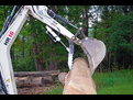 Action shot! HR16 picks up a stone aided by the HT830 mini hydraulic excavator thumb