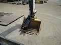 HT830 mini excavator thumb with USA Attachments logo visible
