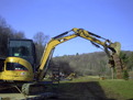 CAT 303.5C CR mini excavator with ht830 hydraulic mini excavator thumb by USA Attachments lifts debris