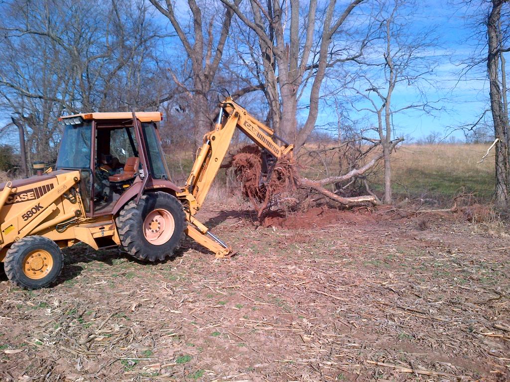 MT1035 thumb installed on CASE 580K backhoe