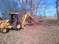 MT1035 thumb installed on CASE 580K backhoe