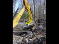 Another shot of the MT1230 bucket thumb picking up a large stone.