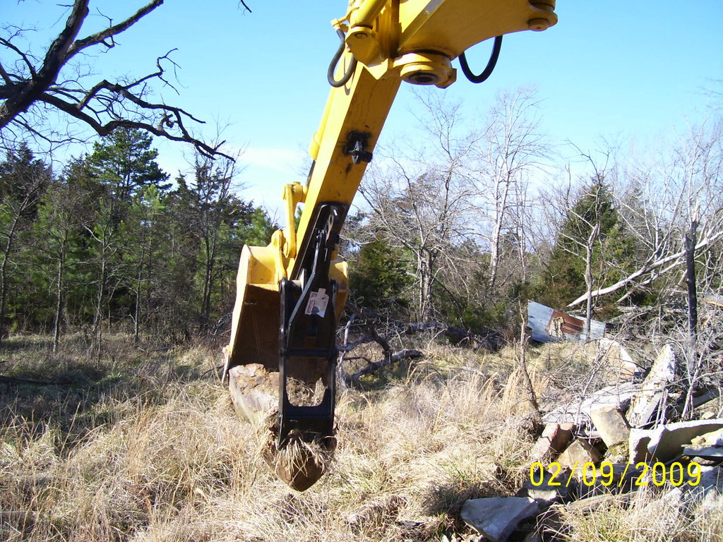 Excavator thumb in action! See the mt1240 thumb picking up a large stone. Installed on a KOMATSU PC75UU