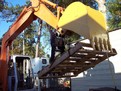 MT1240 excavator thumb picking up a pallet. The bucket in this photo was also made from USA Attachments.