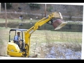 DEERE 27C excavator with a MT1240 excavator thumb, picking up an old tub.