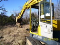 Komatsu PC75UU picking up a large stone with MT140 excavator thumb by USA Attachments