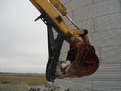 MT2458 thumb holding rocks inside the bucket