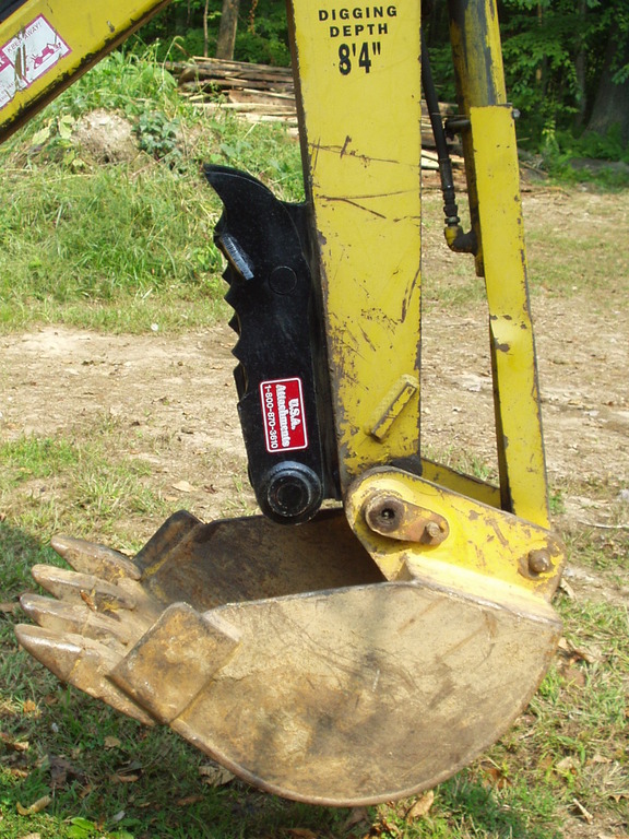 MT618 mini thumb in the folded position on a Terramite T5C compact loader backhoe