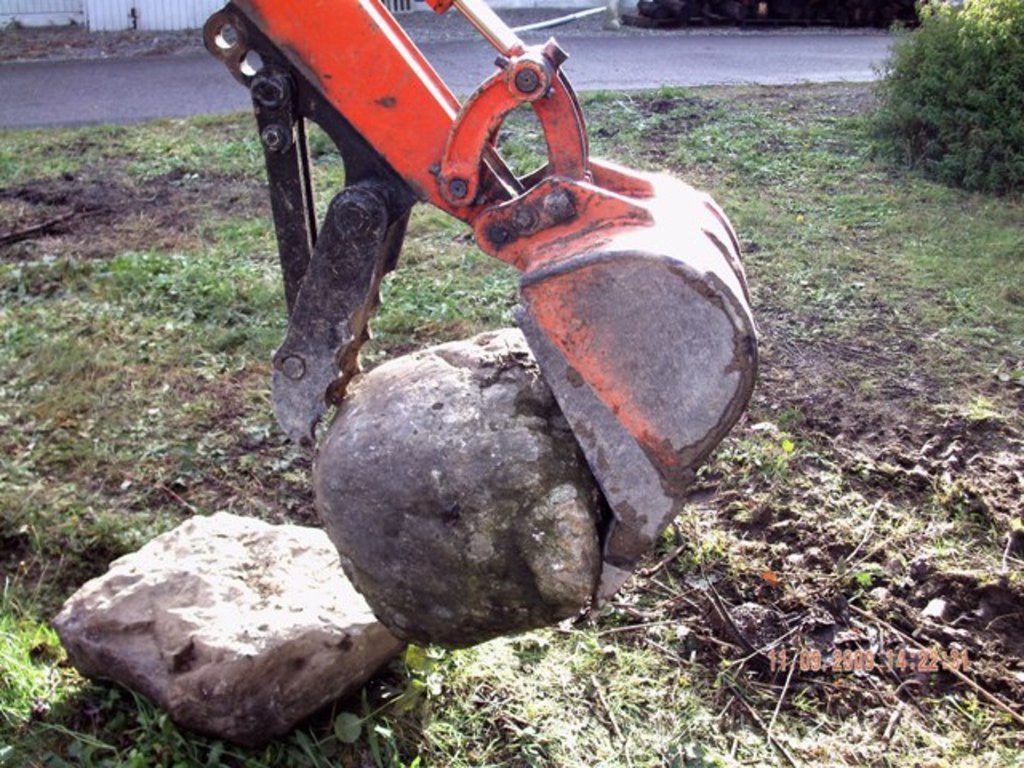 KUBOTA KH-41 with USA Attachments mini thumb installed grasping a large stone