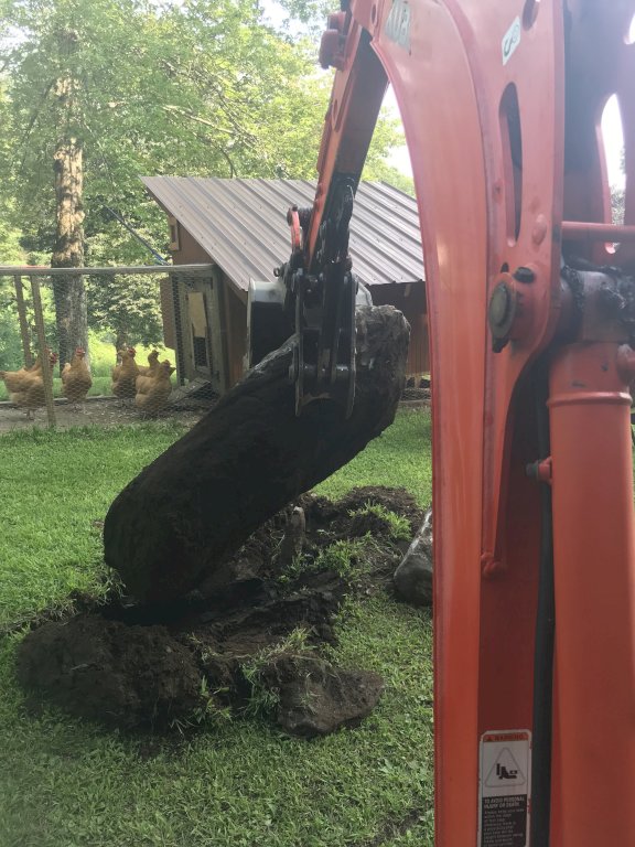 Mt618 mini excavator thumb lifts a stone