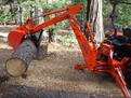 MT618 mini excavator thumb on a Kubota BH90 backhoe log lifting 1