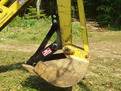Profile of an MT618 thumb installed on a Terramite T5C compact loader backhoe.