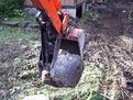 MT618, 6"x18" mini thumb installed on a Kubota KH-41 mini excavator picking up a stone