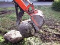 KUBOTA KH-41 with USA Attachments mini thumb installed grasping a large stone