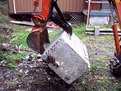 Kubota KH-41 excavator with 6"x18" mini thumb installed holding a block