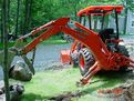 Another view of the MT824 thumb installed on the Kubota L39 mini backhoe moving stones.