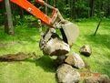 MT824 mini thumb moving stones installed on a KUBOTA L39 mini backhoe.