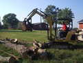 CAT 302.5 excavator picking up logs with MT824 mini excavator thumb by USA Attachments