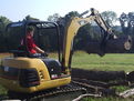 CAT 302.5 mini excavator with MT824 mini excavator thumb picking up logs
