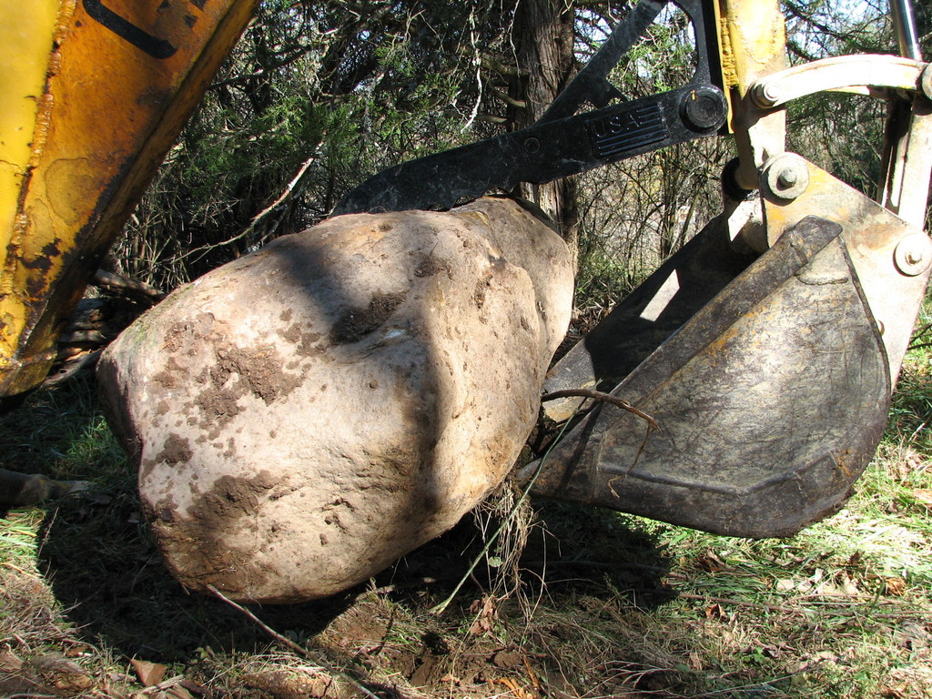 Case backhoe with USA Attachments mt830 mini thumb moves a stone.