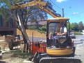 CAT 303 SR with mini excavator thumb lifts concrete slab in Australia