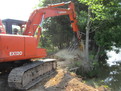 USA Attachments tree stumper installed on a HITACHI EX120